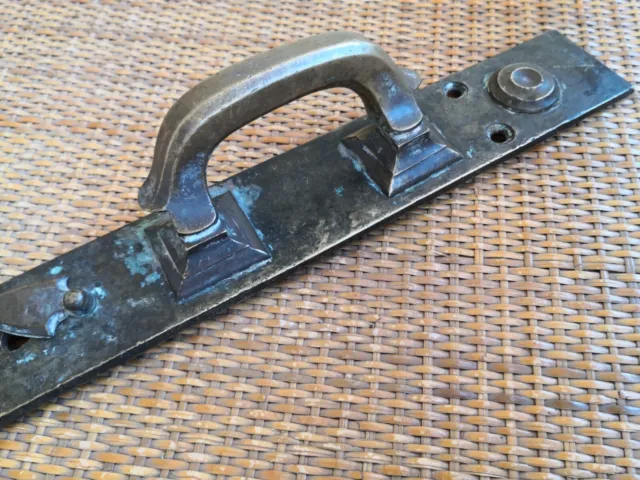 Old door handle late 19th century brand. Large bronze door handle with a keyhole