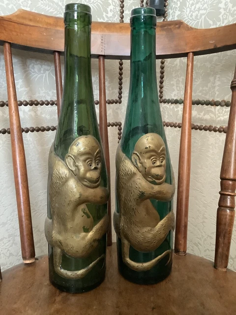 pair of vintage green and gold clinging monkey wine bottles