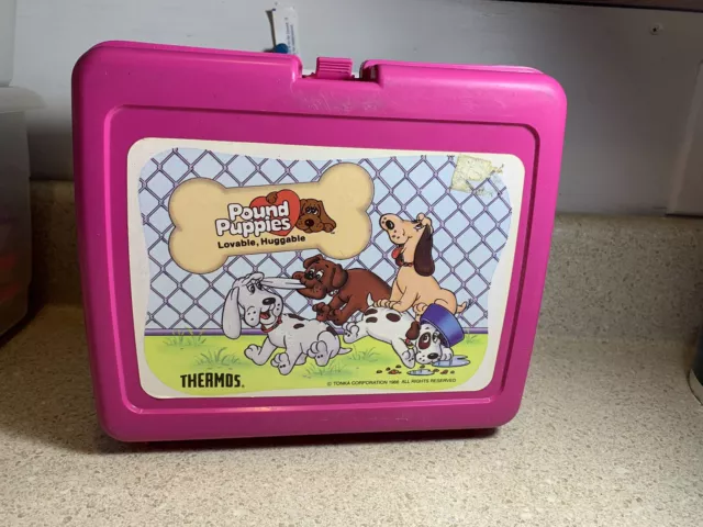 https://www.picclickimg.com/mz4AAOSwRoxk0Def/Vintage-1986-Rare-Pound-Puppies-Thermos-Lunch-Box.webp