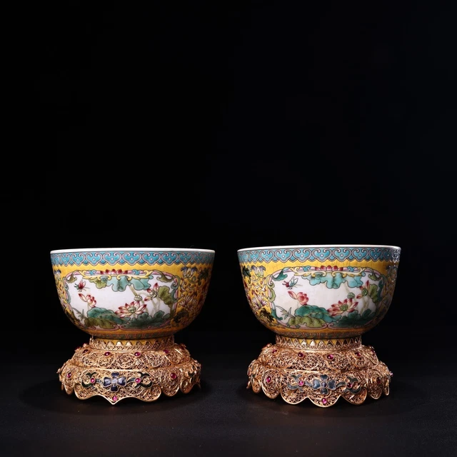 A pair of Qing Dynasty enamel bowls with hand-painted wire plated gold bases