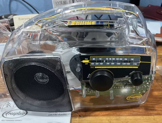 Freeplay Self Powered AM/FM Radio Solar Power Crank CLEAR Solar NEW open Box.