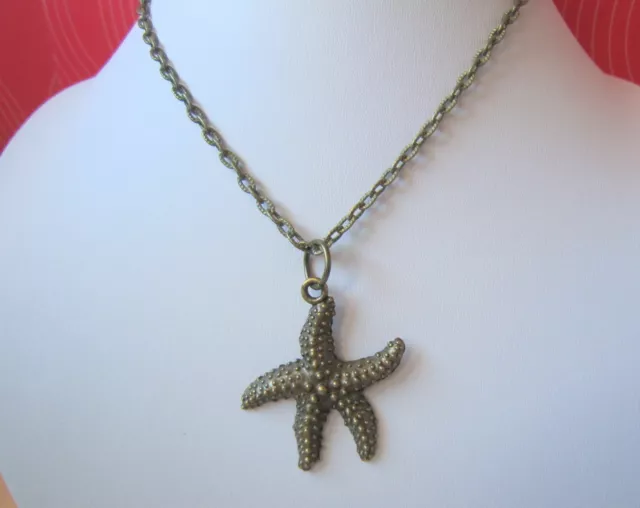 Cadena larga con colgante estrella de mar 40 mm y 58 cm en bronce bisutería