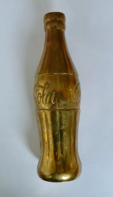 Vintage Coca Cola Bottle Cast is Brass.      7 inches tall.