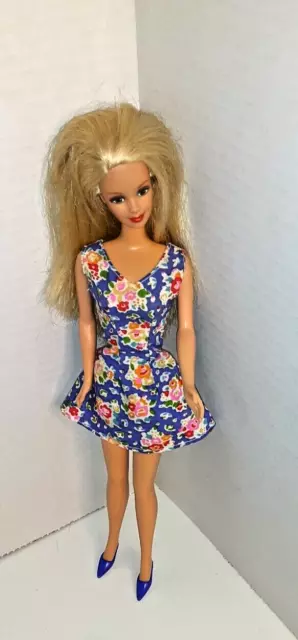 Barbie doll ,1991 ,blonde hair blue eyes. wearing blue floral dress blue hee,