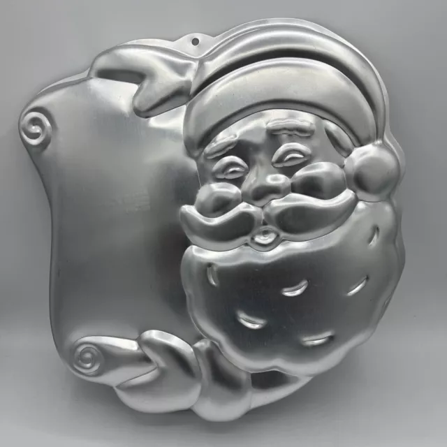 https://www.picclickimg.com/nAoAAOSwh~BlWRkA/Wilton-Christmas-Cake-Pan-Santa-Claus-Naughty-Nice.webp