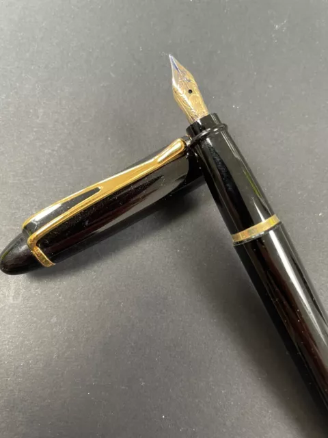 A Good Aurora Ipsilon Fountain Pen. Black Lacquer And Gold Trim.  14K Gold Nib.