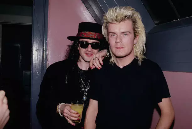 songwriter musician Wayne Hussey wearing a black hat with a red pa- Old Photo