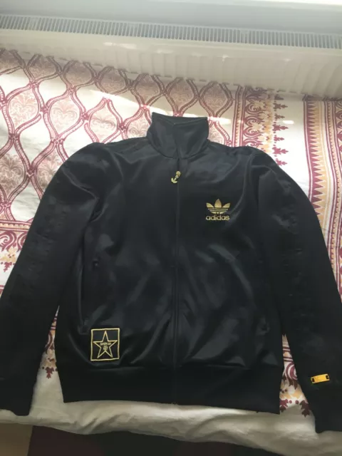 Adidas superstar black clearance and gold jacket