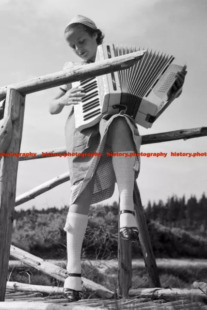 F000738 A young woman playing her accordion. BdM. Germany 1930s