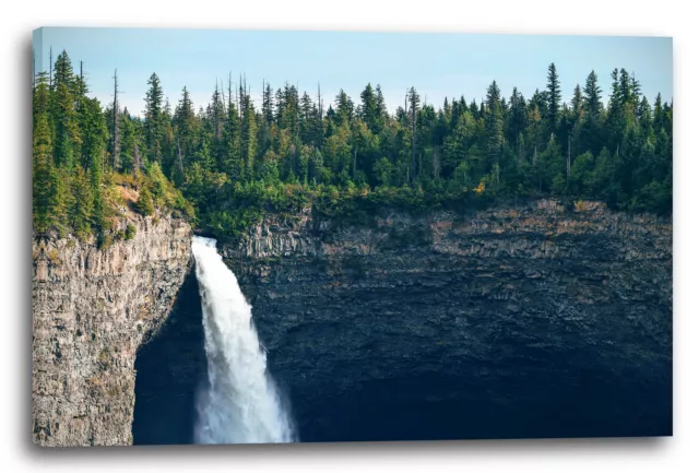 Canvas/Frames Nature images Waterfall flows down on huge rock wall, above fores