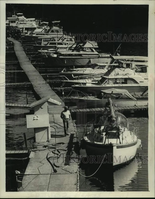 1982 Press Photo Man passes boats moored at Schenectady Yacht Club, Rexford, NY