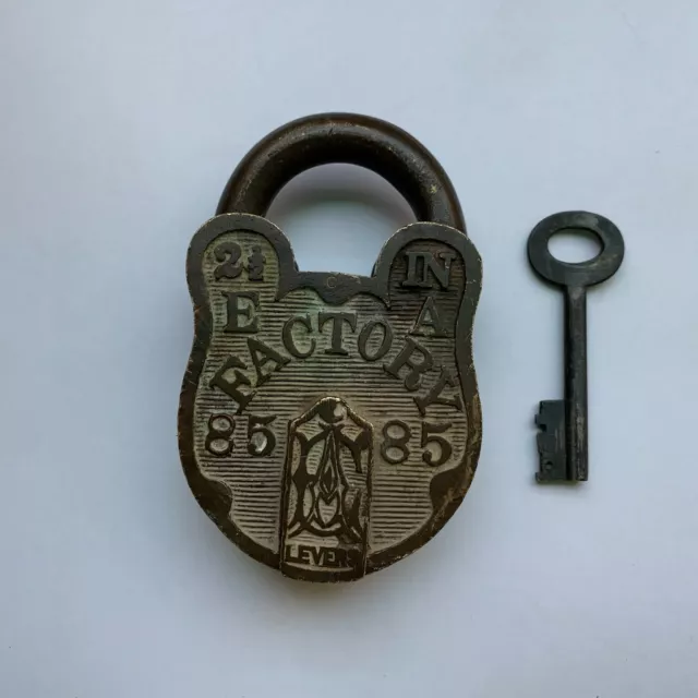 An old or antique brass padlock or lock with key collectible carving