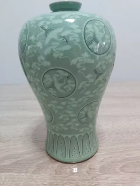 A lovely chinese/oriental celadon vase with cranes 9 " tall mark to base