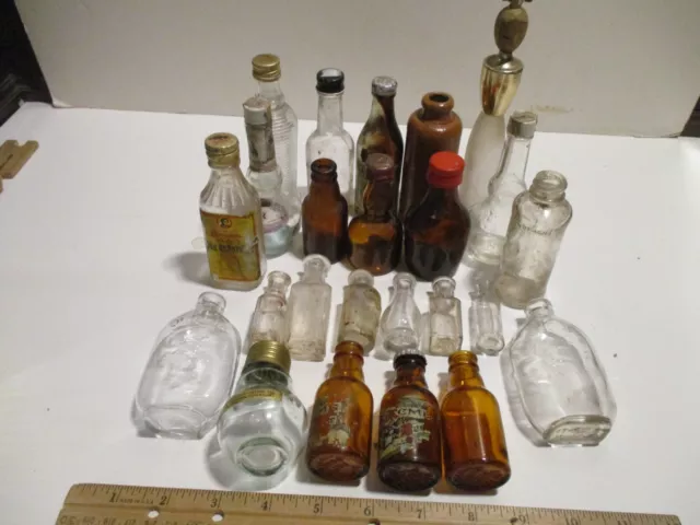 An Assortment Of 24 Empty Miniature Liquor Bottles.