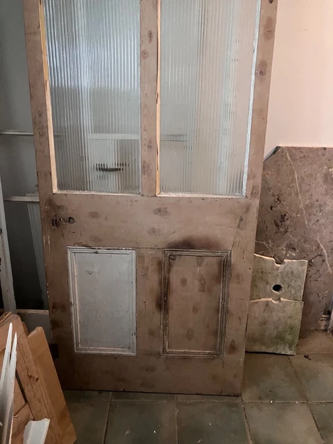 Large reclaimed pine door witth reeded glazed upper panels