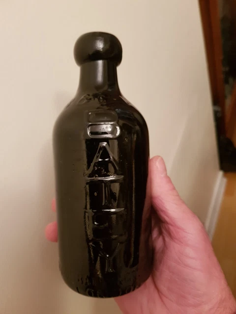 Black Glass Dumpy Ginger Beer Bottle From London, Good Condition.
