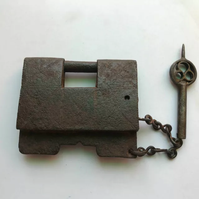 An old antique iron trick or puzzle padlock lock with barbed spring mechanism