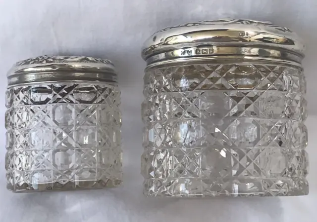 Pair Antique Glass and Sterling Silver Repousse Lid Vanity Jars, 1906 and 1910