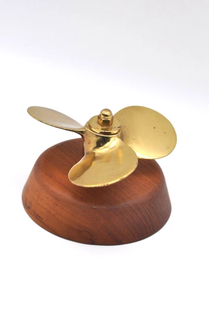 brass propeller on wood base