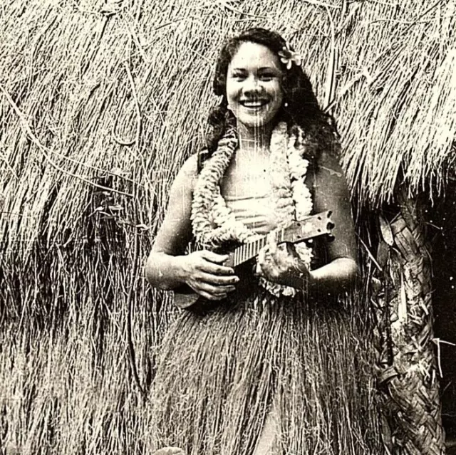 WWII Era Photo Hawaiian Hula Girl Posing Wearing Grass Skirt Ukelele Lei Hale