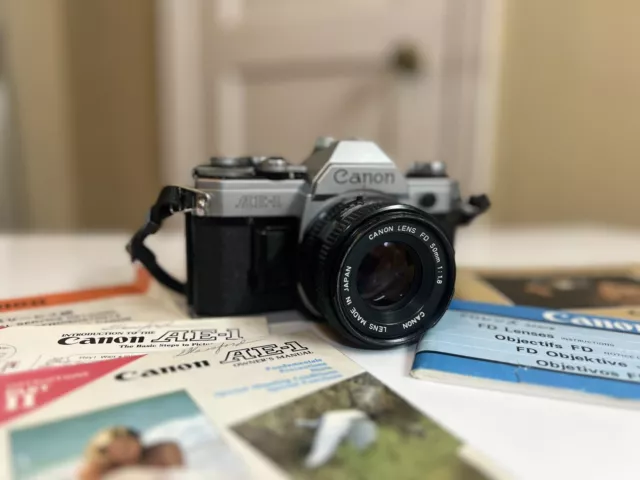 Canon AE-1 Program 35mm Manual SLR Film Camera with 50mm 1:1.8 Lens, And Manuals