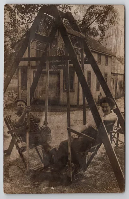 RPPC Lovely Couple Man Woman on Face to Face Swing Glider c1908 Postcard G21