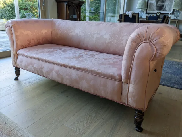 Victorian drop arm chesterfield sofa in pink damask with tapered legs