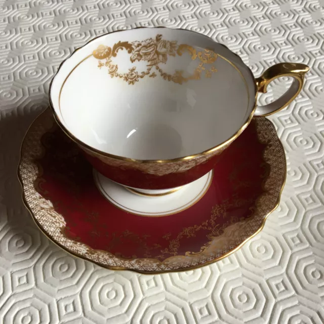 Crown Staffordshire bone china claret and gold teacup and saucer. 