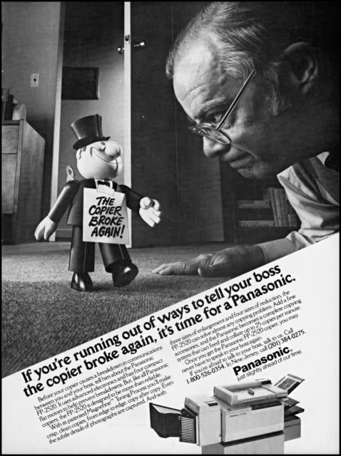1984 Wind up toy man tells boss Panasonic copiers retro photo print ad S20
