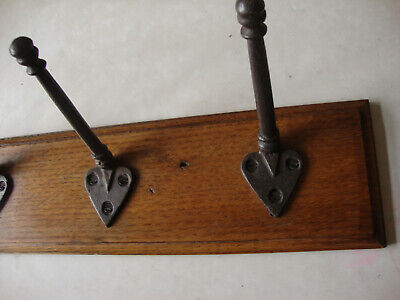 Antique original cast iron coat rack hooks on reclaimed oak board 2
