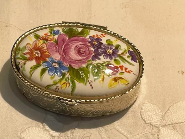 a lovely hand painted floral design gilt pill box