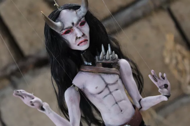 Puppet doll in the form of a Japanese demon. Creepy, gothic horror doll.