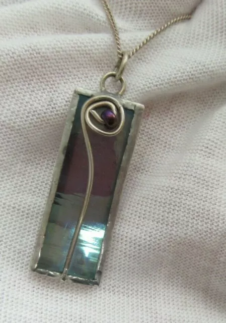 An unusual sterling silver necklace with a Mackintosh inspired pendant