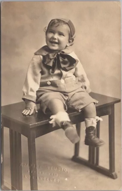 Vintage 1910s Studio Photo RPPC Postcard Very Happy Smiling Little Boy on Table