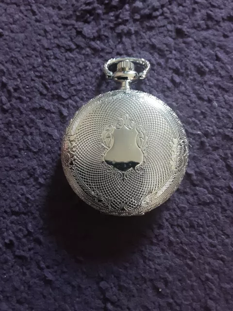 small silver coloured pocket watch