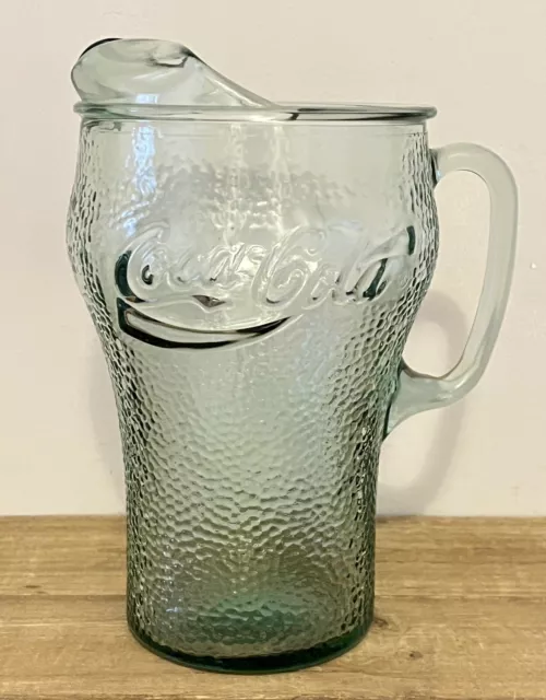 https://www.picclickimg.com/qAoAAOSwkxFkxa8F/Vintage-Coca-Cola-Heavy-Green-Pebbled-Glass-Pitcher-With.webp