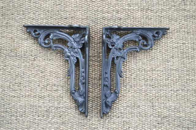 A pair of cast iron Victorian style foliage shelf brackets shelving cistern