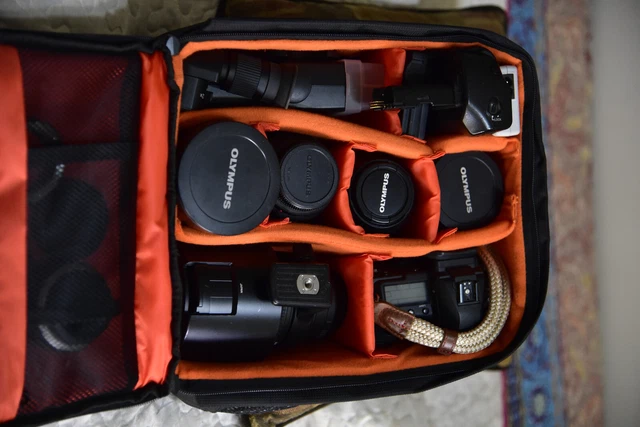 Olympus EVOLT E-5 12.3MP Digital SLR Camera - Black with lenses and accessories.