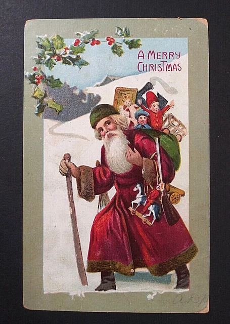A Merry Christmas Santa in Green Hat Toys in Snow Embossed Postcard c1910s