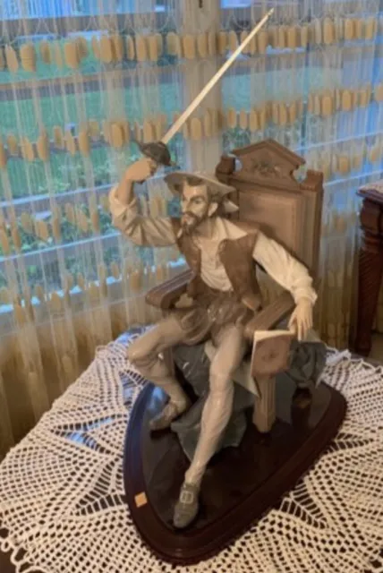 LLadro Porcelain Seated Don Quixote Quijote sitting in a chair with a high back