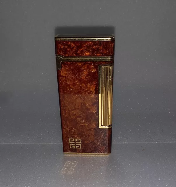 Vintage Givenchy 2000 enamel and gold plated lighter in working condition.