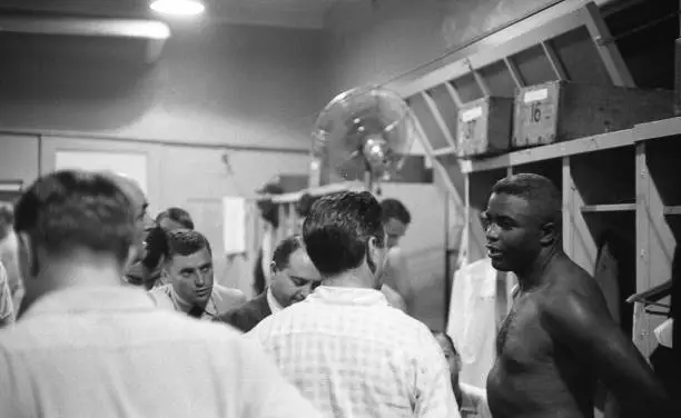 Brooklyn Dodgers Jackie Robinson talks in the locker room vs St. L - Old Photo 2