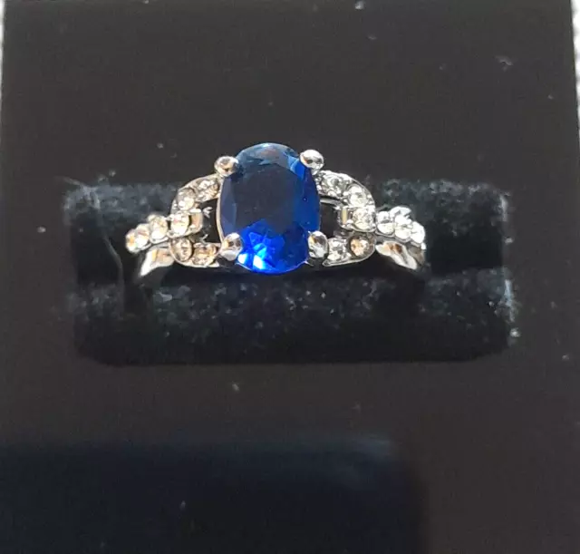 Silver Plated Ring with Oval Blue and Small Clear Gemstones