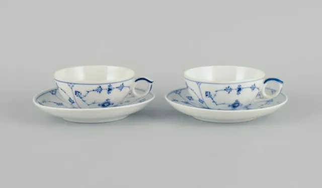 Two sets of Royal Copenhagen Blue Fluted Plain tea cups and saucers.