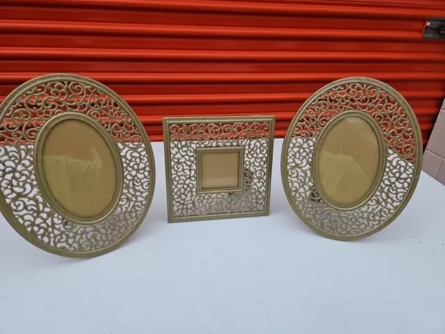 Metal picture Frame Set of 3 gold in color. Ovals are 10" tall 4x6 pic. square