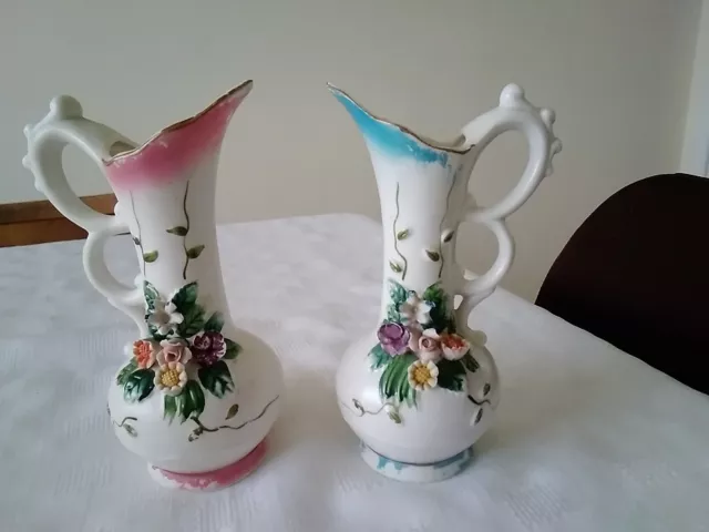 2 Vintage Vase/Pitcher Raised Flower Bisque Capodimonte Style. 1 Blue, 1 Pink.