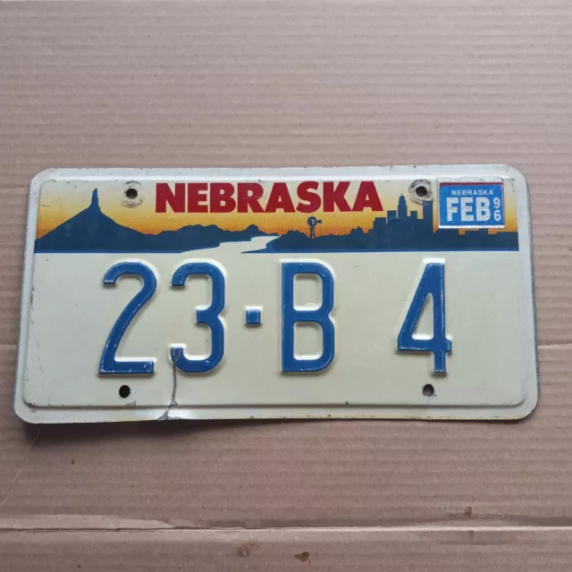1996 Nebraska License Plate - "23-B 4" (blue on white) FEB 96 Sticker