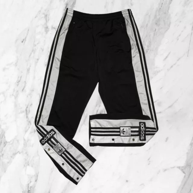 Pantaloni con i bottoni laterali adidas 2025