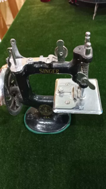 Collectible vintage miniature sewing machine in it's original box.