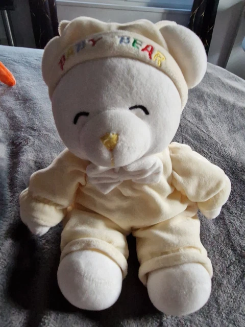 Peluche doudou ours Baby Bear GIPSY combinaison jaune nœud blanc 30 cm